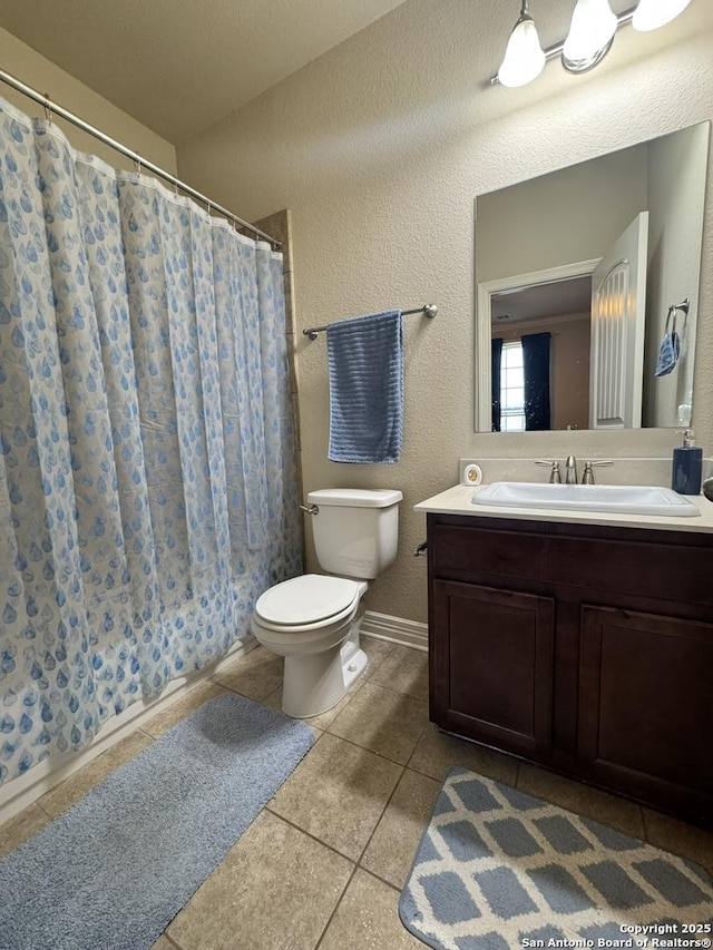 9035 Monument Parke, San Antonio, TX 78254 - full bathroom featuring tile patterned floors, a textured wall, toilet, vanity, and a shower with curtain