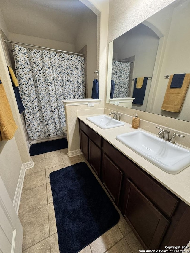 9035 Monument Parke, San Antonio, TX 78254 - bathroom featuring tile patterned floors, a shower with curtain, a sink, and double vanity