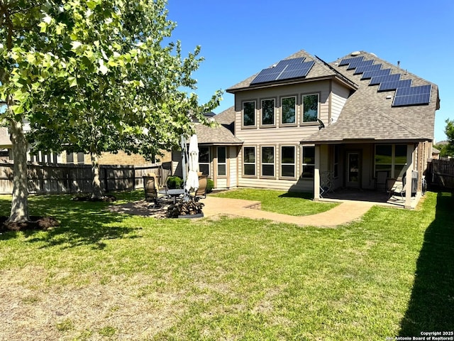 9035 Monument Parke, San Antonio, TX 78254 - rear view of property with solar panels, a patio area, a lawn, and a shingled roof