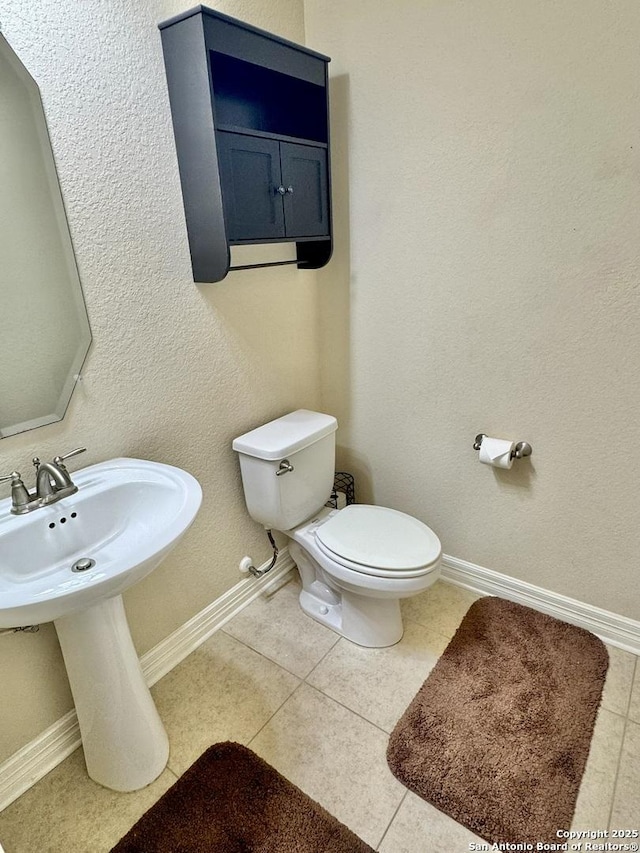 9035 Monument Parke, San Antonio, TX 78254 - half bath with tile patterned floors, baseboards, and toilet