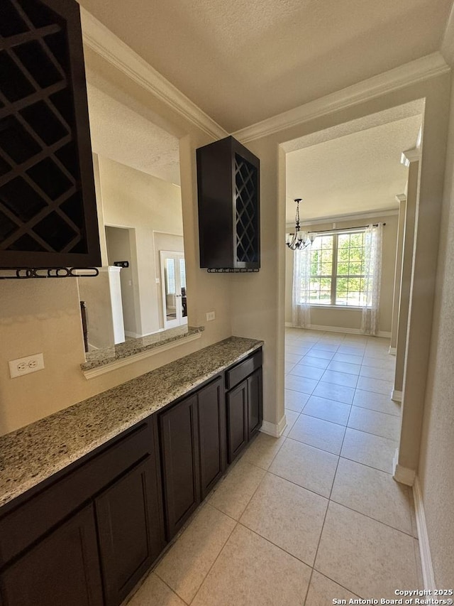 9035 Monument Parke, San Antonio, TX 78254 - interior space featuring a textured ceiling, light tile patterned flooring, baseboards, a chandelier, and ornamental molding