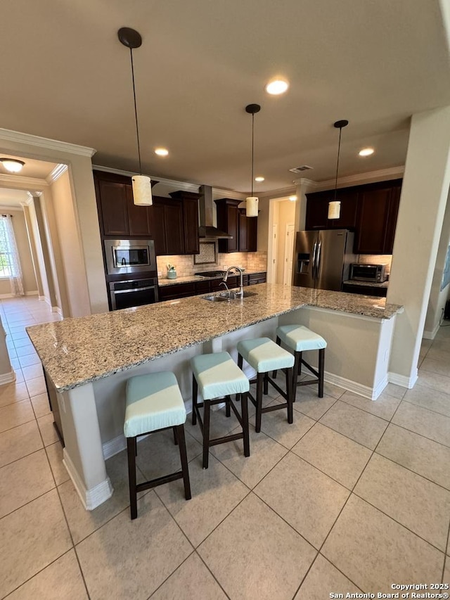 9035 Monument Parke, San Antonio, TX 78254 - kitchen featuring stainless steel appliances, wall chimney range hood, light tile patterned floors, crown molding, and tasteful backsplash