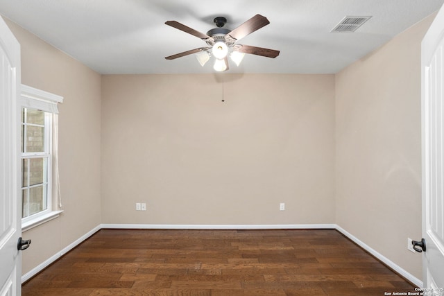 unfurnished room with visible vents, baseboards, a ceiling fan, and dark wood-style floors