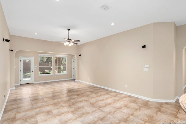 spare room with arched walkways, visible vents, a ceiling fan, and recessed lighting