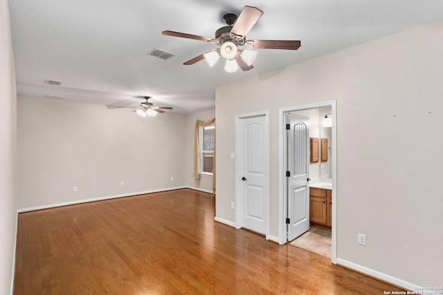 unfurnished bedroom featuring baseboards, visible vents, and light wood-type flooring