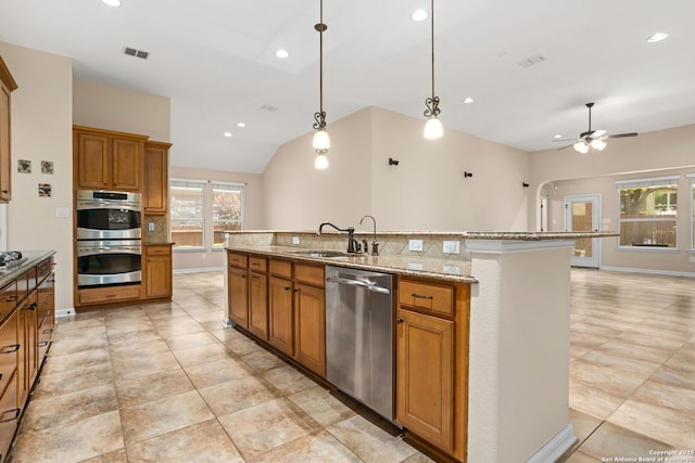 kitchen featuring a sink, visible vents, a ceiling fan, brown cabinets, and appliances with stainless steel finishes