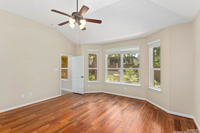spare room featuring baseboards, vaulted ceiling, ceiling fan, and wood finished floors