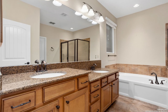 bathroom featuring visible vents, a sink, double vanity, and a stall shower