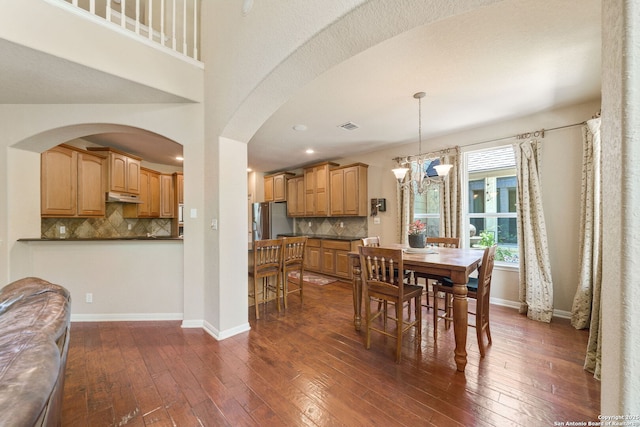 3329 Navasota Cir, San Antonio, TX 78259 - dining space featuring dark wood-type flooring, a chandelier, arched walkways, and recessed lighting