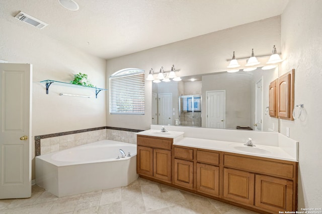 3329 Navasota Cir, San Antonio, TX 78259 - full bathroom featuring double vanity, a garden tub, a shower stall, and tile patterned floors