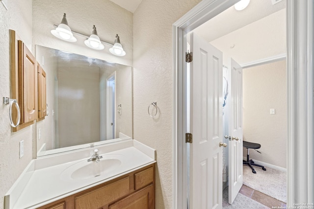 3329 Navasota Cir, San Antonio, TX 78259 - bathroom featuring vanity, a textured wall, and tile patterned flooring
