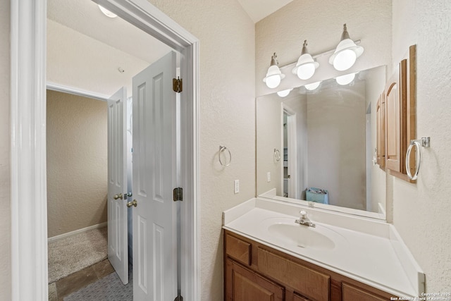 3329 Navasota Cir, San Antonio, TX 78259 - bathroom with a textured wall, vanity, and tile patterned flooring