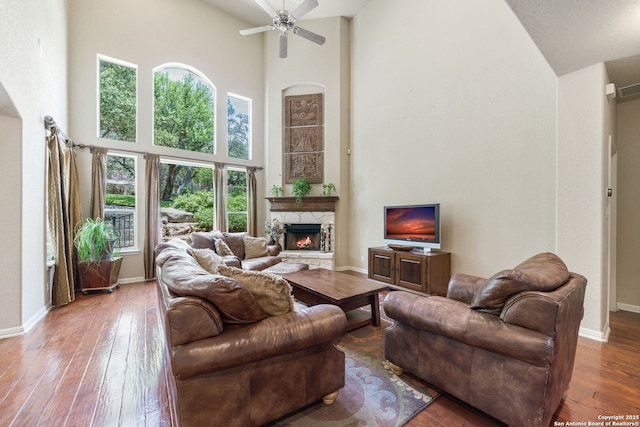 3329 Navasota Cir, San Antonio, TX 78259 - living area with high vaulted ceiling, a stone fireplace, hardwood / wood-style floors, and a ceiling fan