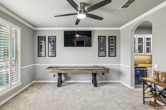 rec room featuring arched walkways, carpet floors, beverage cooler, and visible vents
