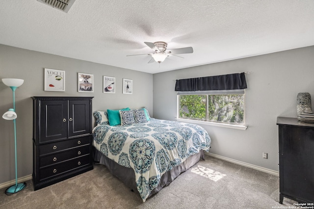 bedroom with visible vents, carpet floors, baseboards, a textured ceiling, and ceiling fan