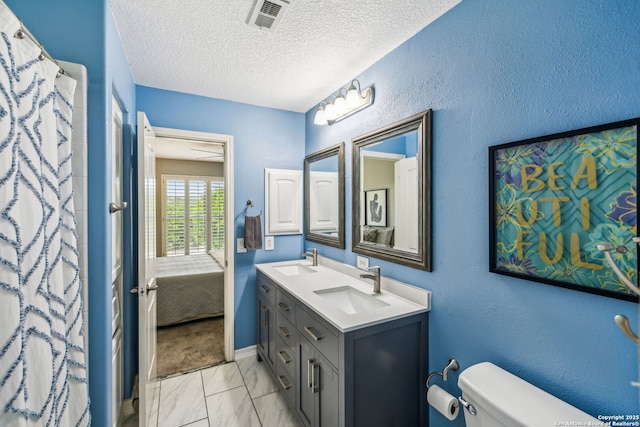 full bathroom with marble finish floor, toilet, a sink, and visible vents