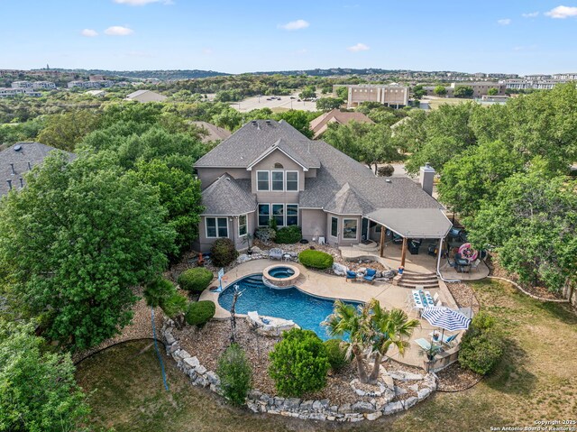 view of pool with a patio and a pool with connected hot tub