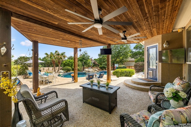 view of patio with fence, a ceiling fan, and a fenced in pool