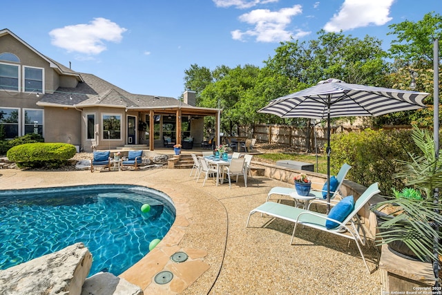 view of pool featuring a patio area, a fenced backyard, a fenced in pool, and outdoor dining space