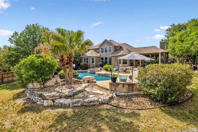 outdoor pool featuring a patio, a fenced backyard, and an outdoor hot tub