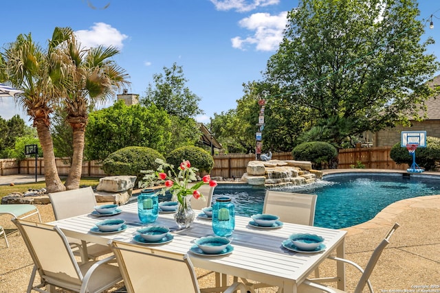 view of pool with a fenced backyard, a patio, a fenced in pool, and outdoor dining area