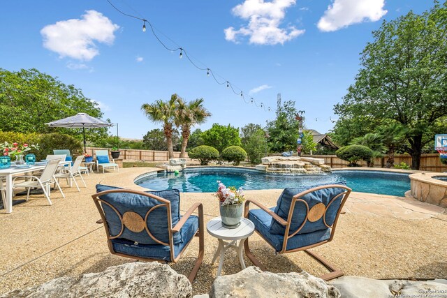 view of swimming pool with a fenced backyard, a patio, and a fenced in pool