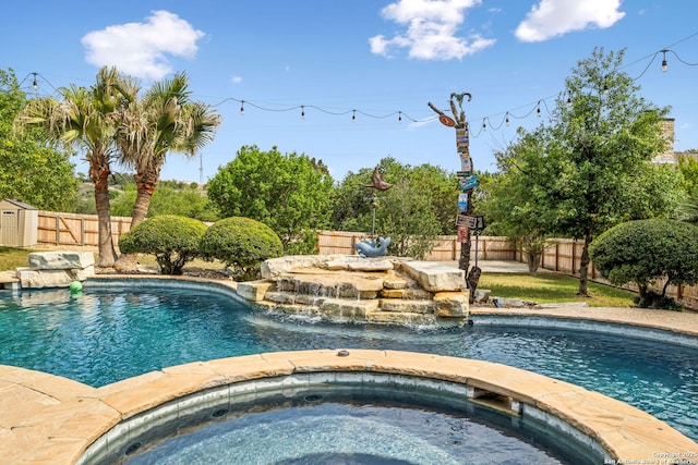 view of pool with a fenced backyard, a shed, a fenced in pool, and an in ground hot tub