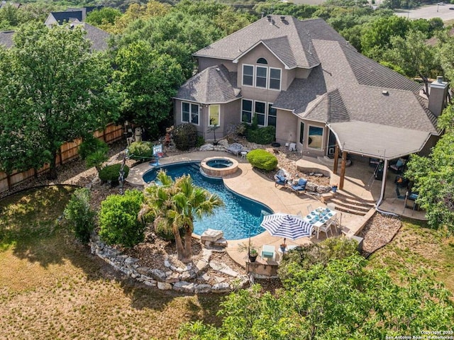 view of swimming pool with a patio area, a fenced in pool, a fenced backyard, and an in ground hot tub