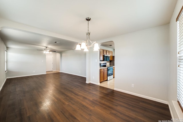interior space with wood finished floors, visible vents, arched walkways, baseboards, and ceiling fan with notable chandelier