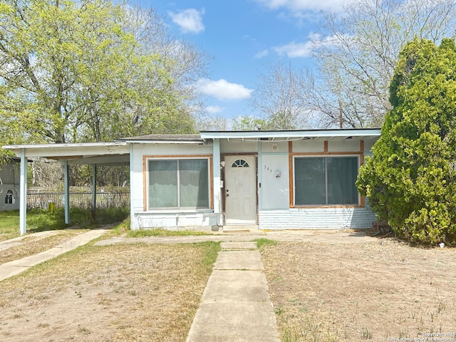 bungalow featuring brick siding