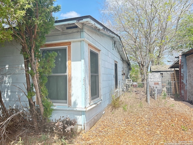 view of home's exterior with fence