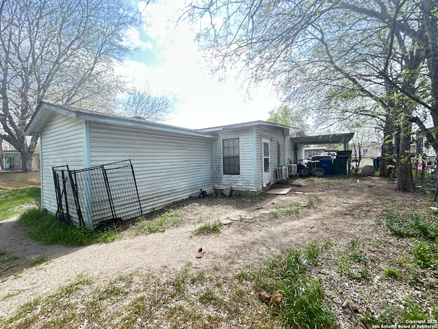 view of side of home featuring fence
