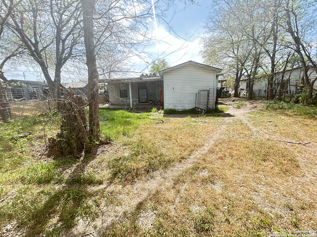 view of yard with a porch and fence