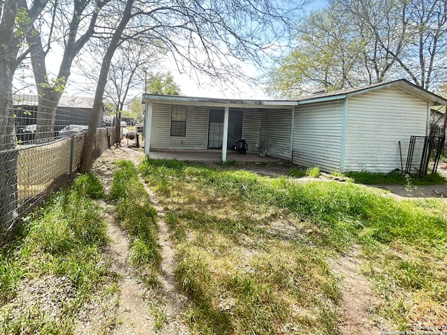 back of property featuring fence