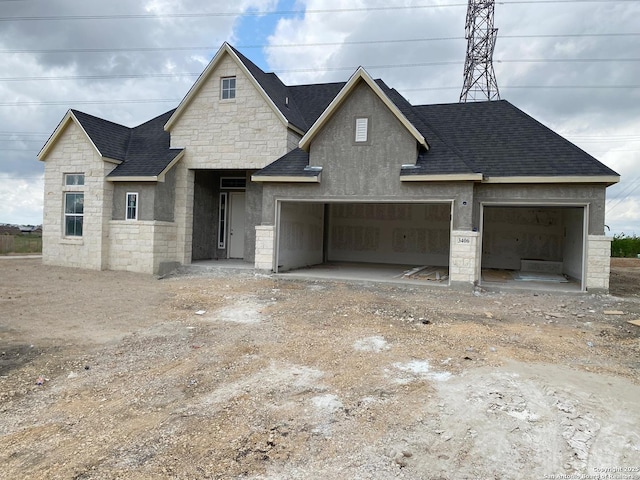 property in mid-construction featuring stone siding, driveway, roof with shingles, and a garage