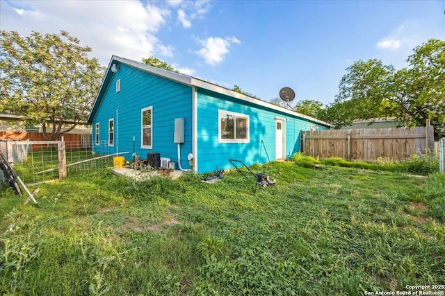 610 Novella, Adkins, TX 78101 - rear view of house featuring central air condition unit and fence
