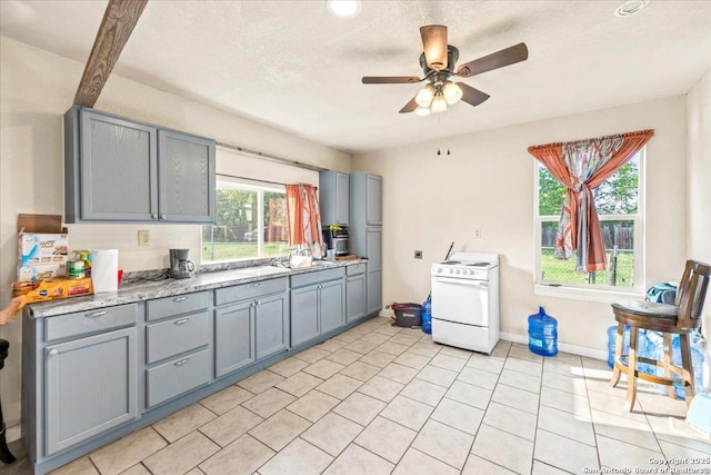 610 Novella, Adkins, TX 78101 - kitchen featuring a ceiling fan, light countertops, white range with electric cooktop, and gray cabinets