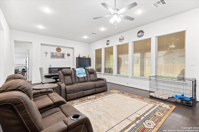 living room with ceiling fan, baseboards, a healthy amount of sunlight, and visible vents