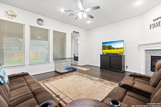 living area with baseboards, visible vents, ceiling fan, and dark wood-style flooring