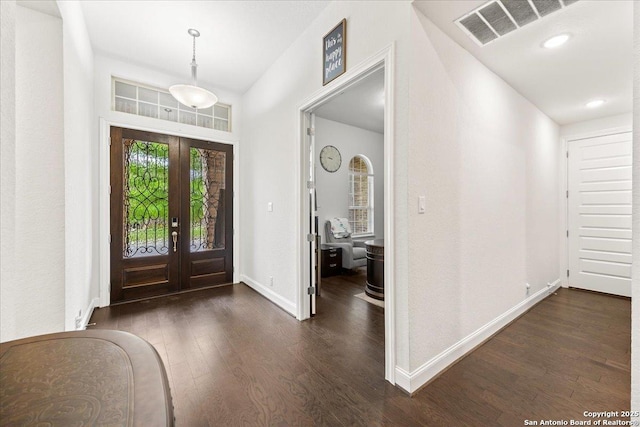 entryway with visible vents, baseboards, dark wood-style flooring, and french doors