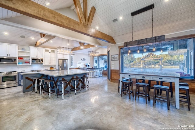 dining room with beamed ceiling, recessed lighting, and finished concrete flooring
