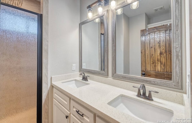 full bathroom with a sink, visible vents, and double vanity