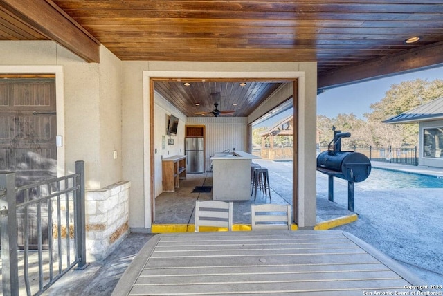 view of patio / terrace featuring outdoor dry bar and a ceiling fan