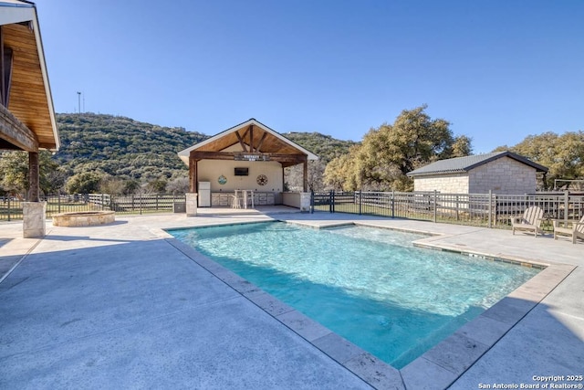 67 Stepping Stone, Concan, TX 78838 - view of pool with a patio area, a fenced in pool, fence, and a mountain view