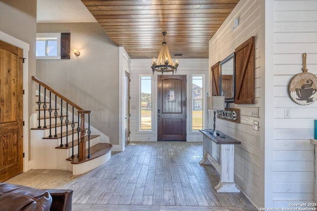 67 Stepping Stone, Concan, TX 78838 - foyer entrance with light wood-type flooring, wood ceiling, stairway, and an inviting chandelier