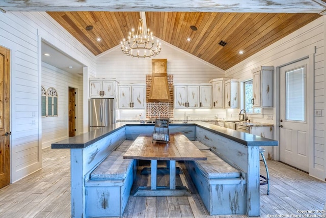 67 Stepping Stone, Concan, TX 78838 - kitchen with wooden ceiling, a chandelier, wooden walls, and freestanding refrigerator