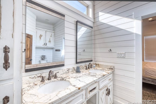 67 Stepping Stone, Concan, TX 78838 - full bath with wooden walls, a sink, and double vanity