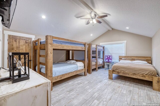 67 Stepping Stone, Concan, TX 78838 - bedroom featuring lofted ceiling with beams, a ceiling fan, wood finished floors, and a textured ceiling