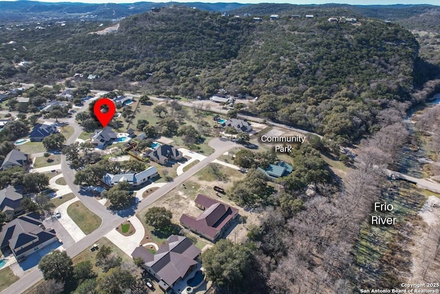 67 Stepping Stone, Concan, TX 78838 - birds eye view of property with a view of trees and a mountain view