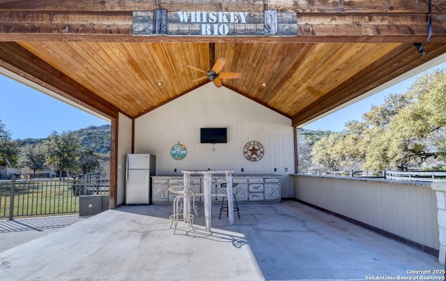 67 Stepping Stone, Concan, TX 78838 - view of patio / terrace with fence, an outdoor kitchen, and ceiling fan